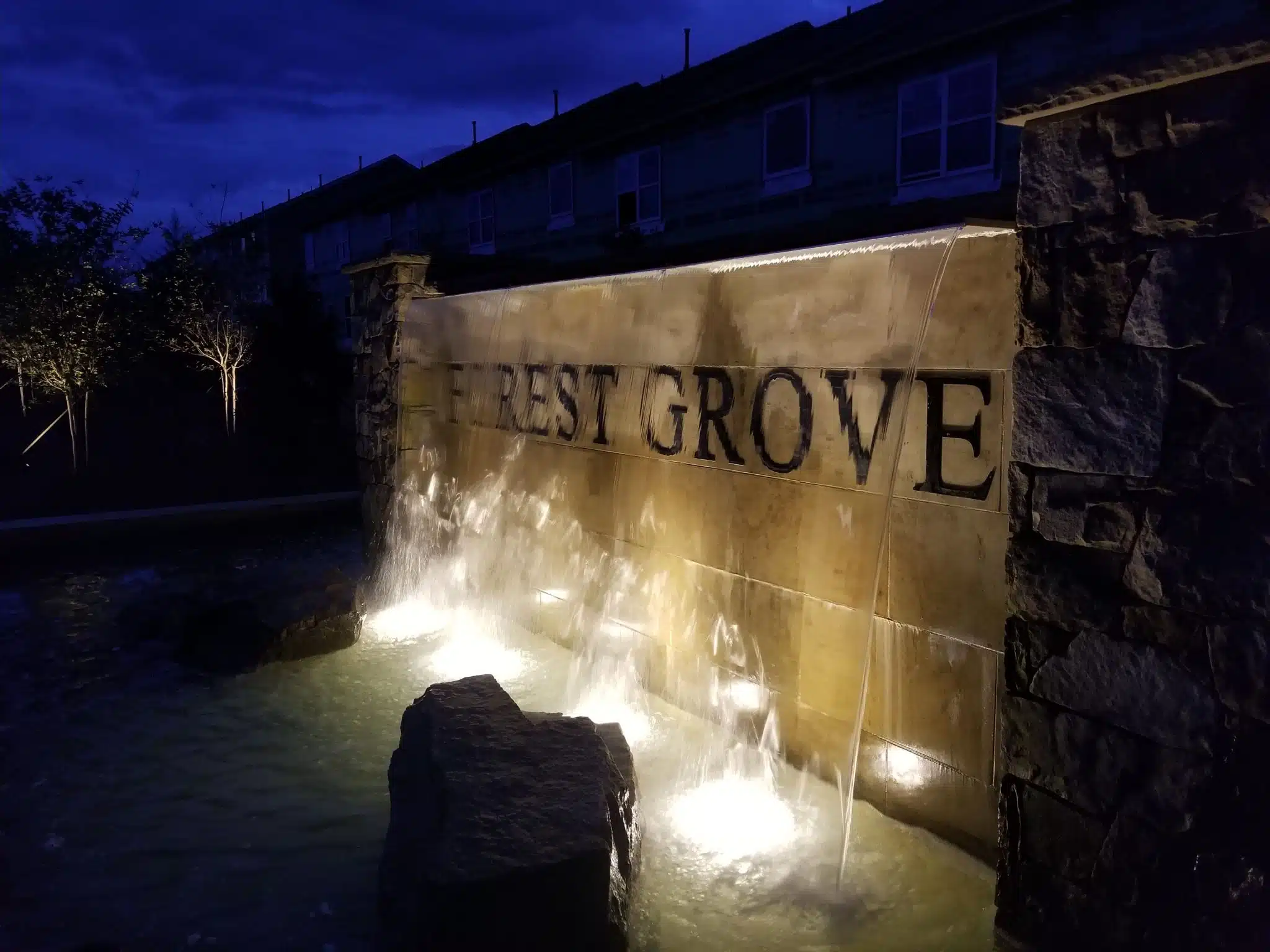 HOA and neighborhood lighting illuminating the West Grove entrance by Landscape Lighting Resources in Charlotte NC
